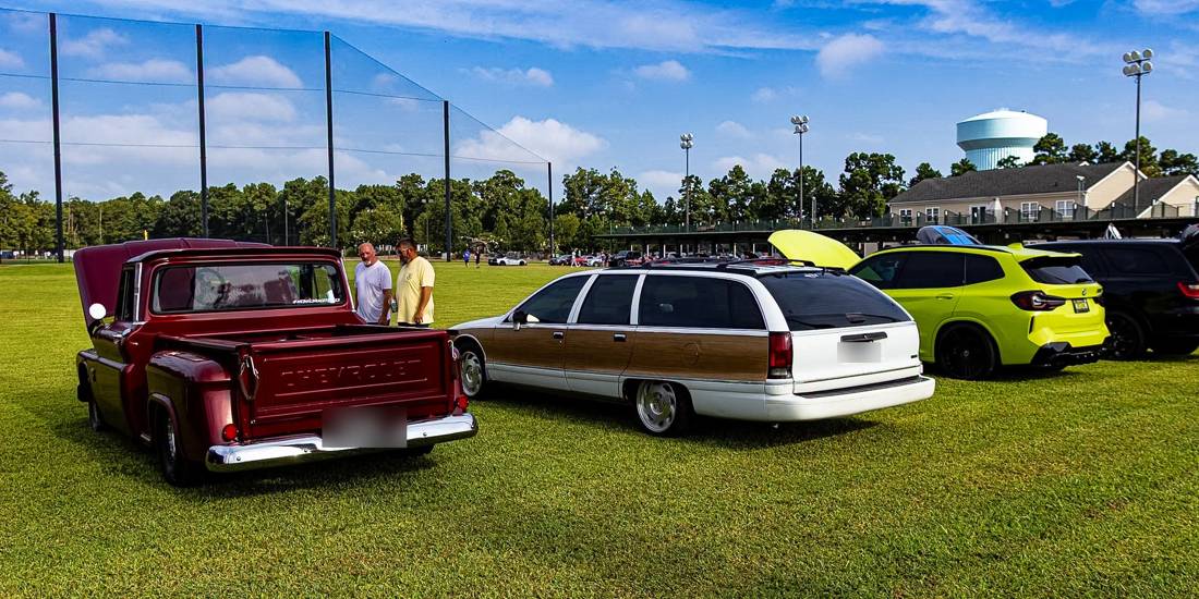 Chevy C10, Caprice wagon, and BMW X3 M on the green