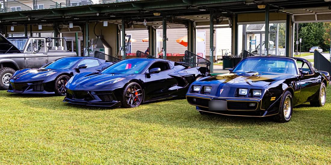 Bandit Trans Am and two C8 Corvettes on the green